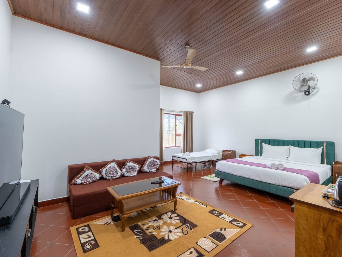 Family Room with king bed, extra bed and sofa set at Zen Garden Vagamon