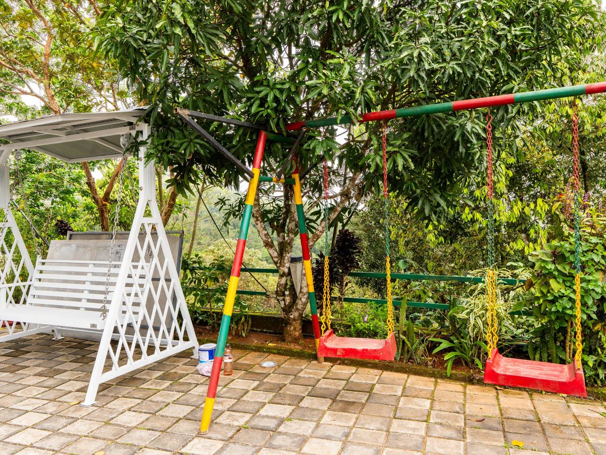 White garden swing and children's swings under the trees at Zen Garden Vagamon
