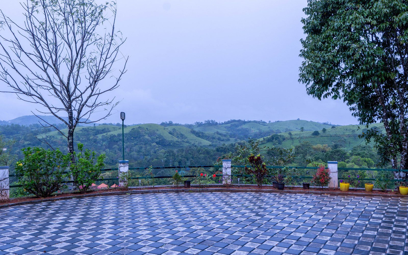 The terrace at Zen Garden Vagamon looking out over green hills and tea gardens